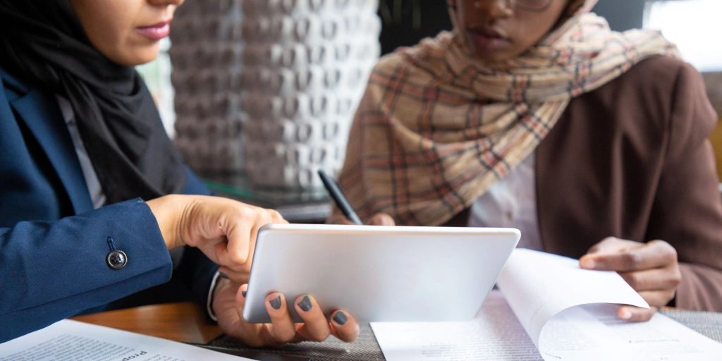 A female lawyer based in dubai is signing a Power of Attorney POA Document with a client