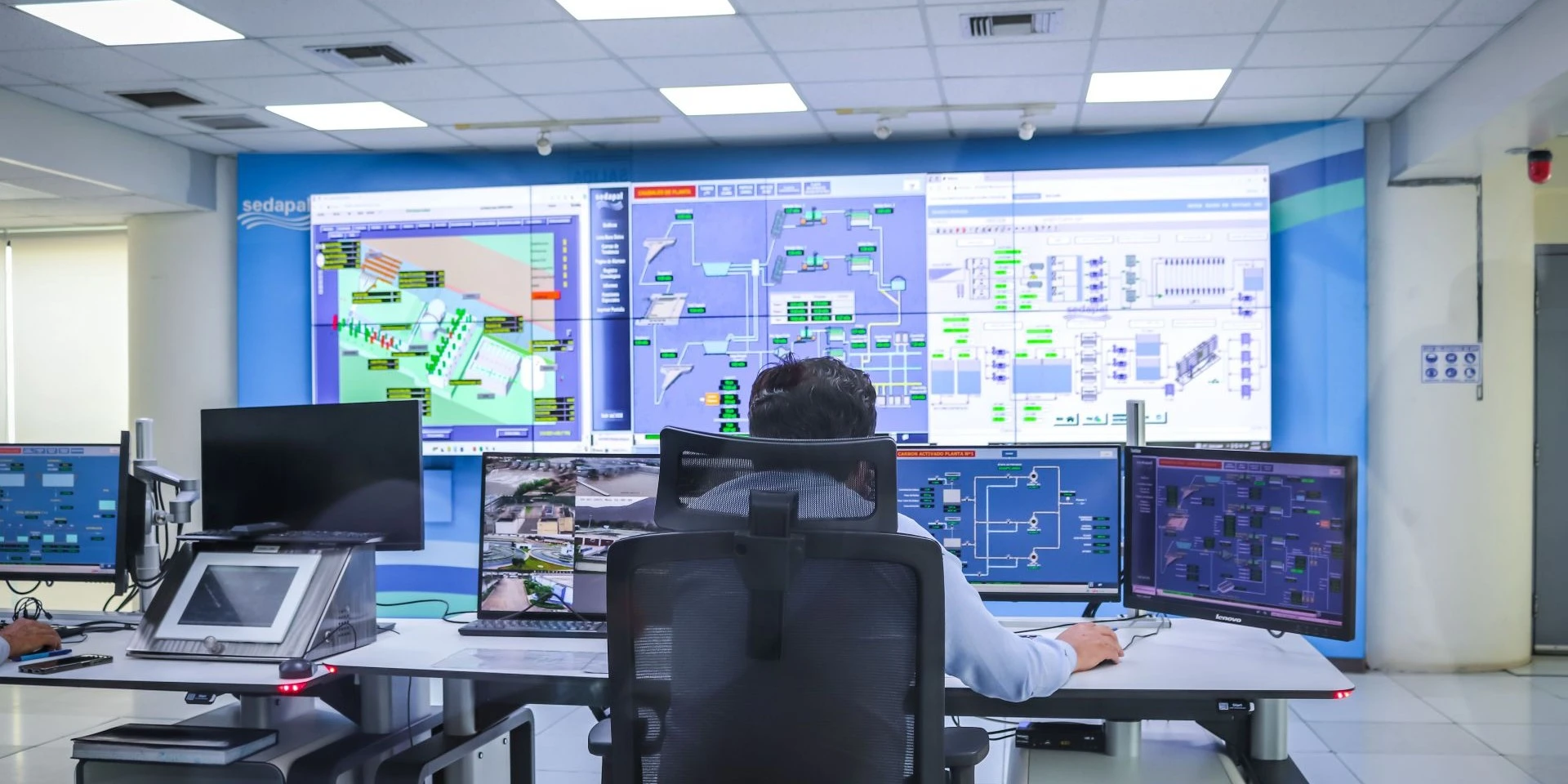An employee running a lot of company operations through multiple screens