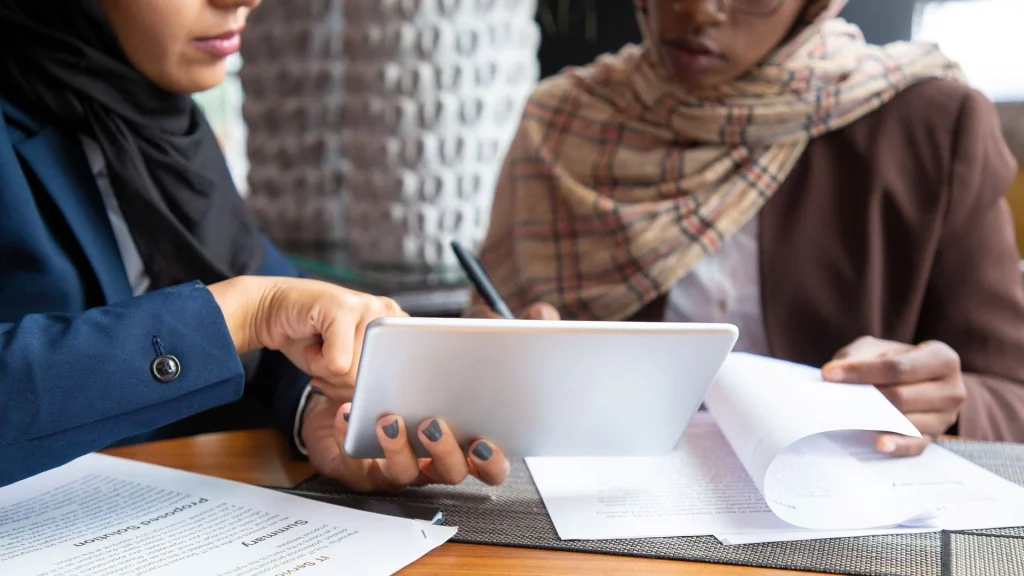 A female lawyer based in dubai is signing a Power of Attorney POA Document with a client