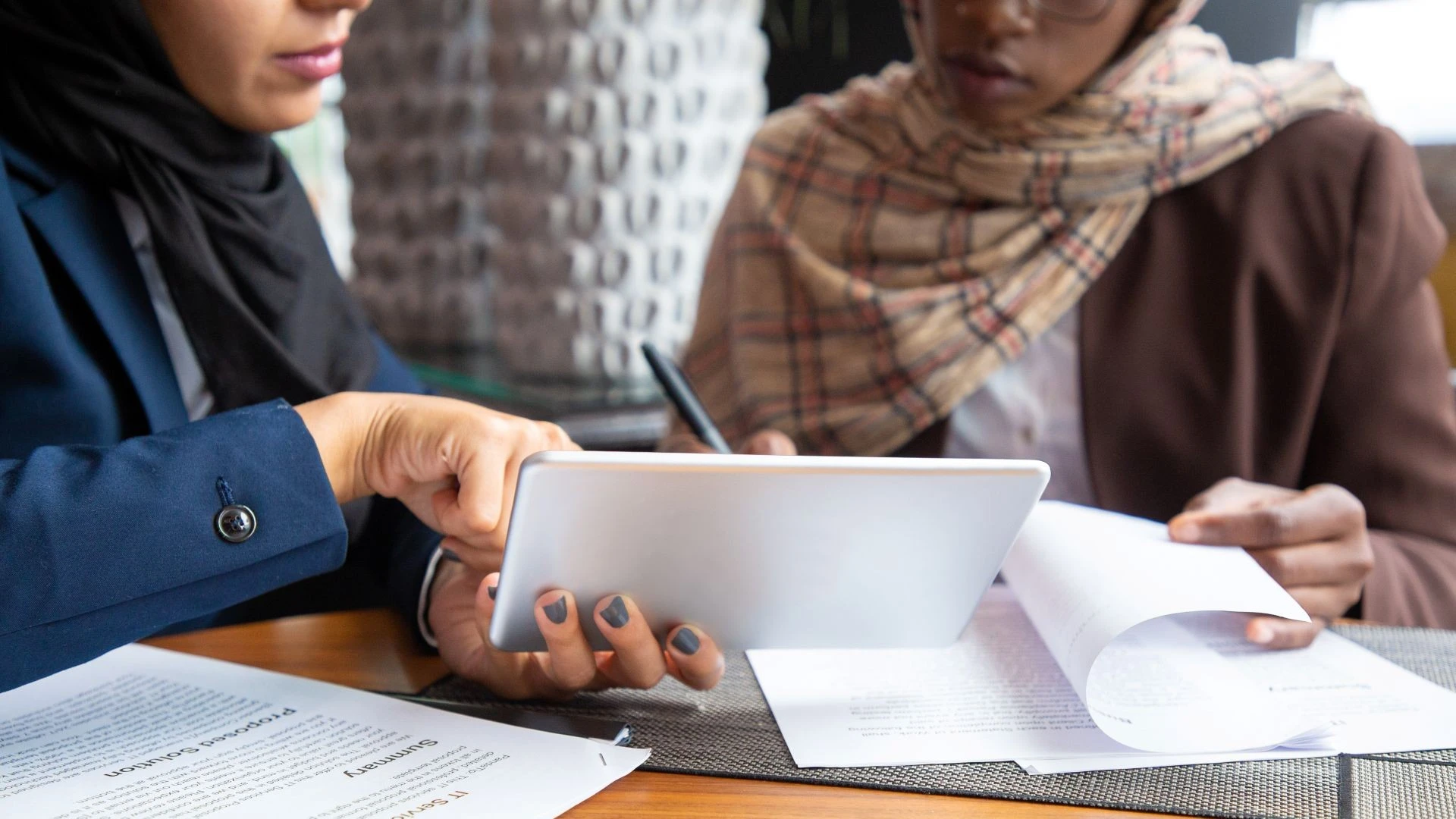 A female lawyer based in dubai is signing a Power of Attorney POA Document with a client